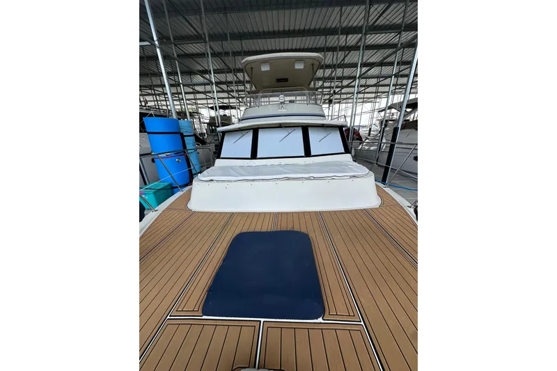 Slide: The Image of 1990 Blue Water 42 Coastal Cruiser with spacious deck in marina setting. - 5