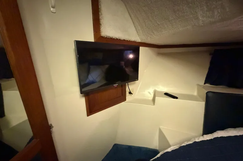 Slide: The Image of Interior of 1990 Blue Water 42 Coastal Cruiser with mounted TV and cozy bedding. - 58