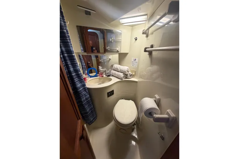 Slide: The Image of Bathroom interior of 1990 Blue Water 42 Coastal Cruiser, featuring compact design and amenities. - 60