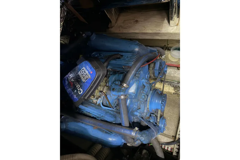 Slide: The Image of Engine of 1990 Blue Water 42 Coastal Cruiser, featuring blue components and hoses. - 62