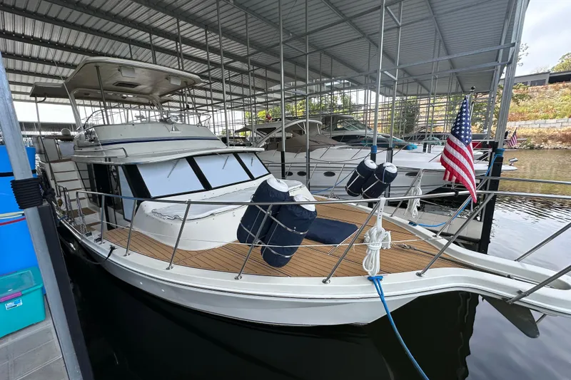 Slide: The Image of 1990 Blue Water 42 Coastal Cruiser docked under a covered marina. - 7