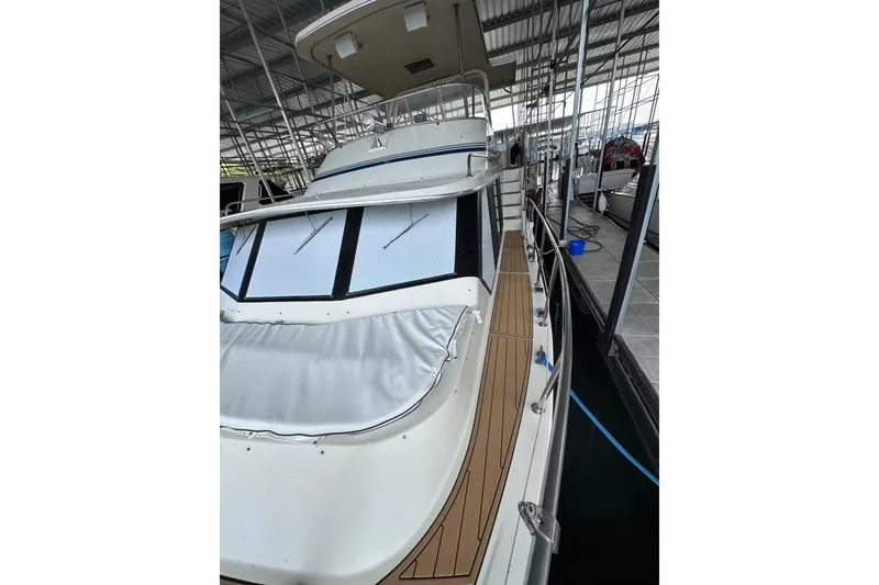 Slide: The Image of 1990 Blue Water 42 Coastal Cruiser docked in a covered marina. - 8