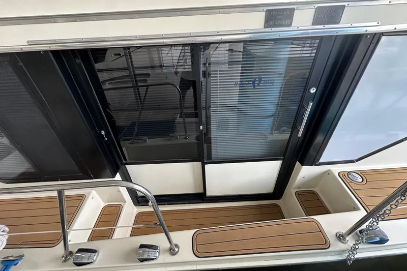 Slide: The Image of 1990 Blue Water 42 Coastal Cruiser boat deck with sliding glass door. - 9