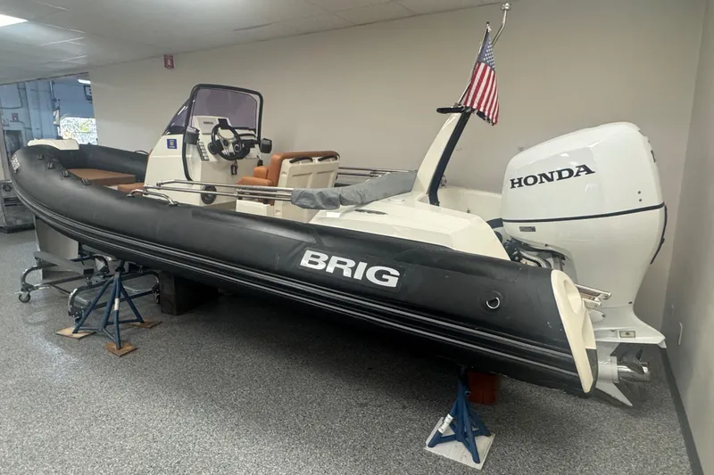 The Image of 2020 Brig Eagle 6.7 boat with Honda engine, displayed indoors on stands. - 0