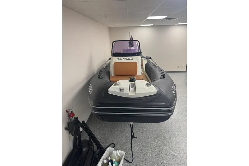 Slide: The Image of 2020 Brig Eagle 6.7 inflatable boat displayed indoors, featuring sleek design and modern seating. - 4