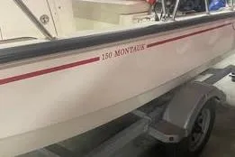Slide: The Image of 2021 Boston Whaler 150 Montauk boat on trailer, side view. - 10