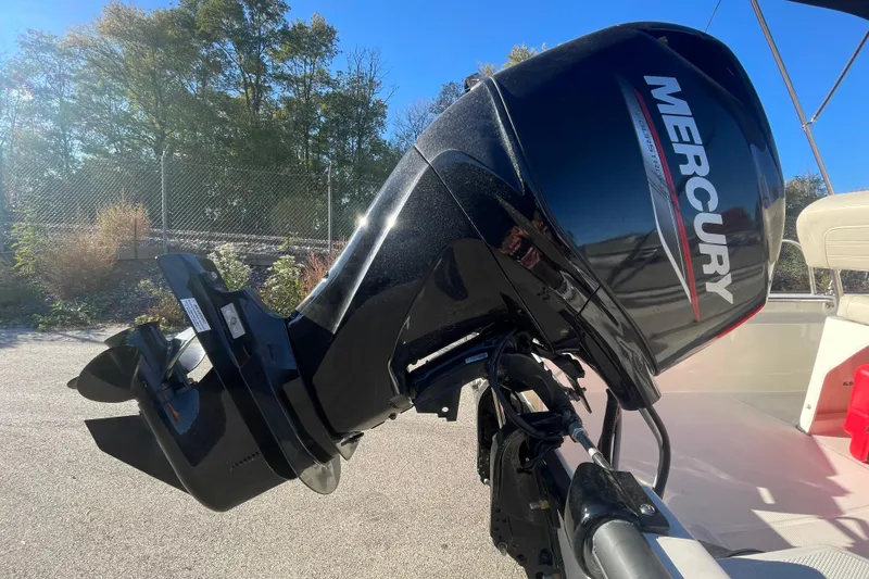 Slide: The Image of 2021 Boston Whaler 150 Montauk with Mercury outboard motor, parked outdoors. - 7