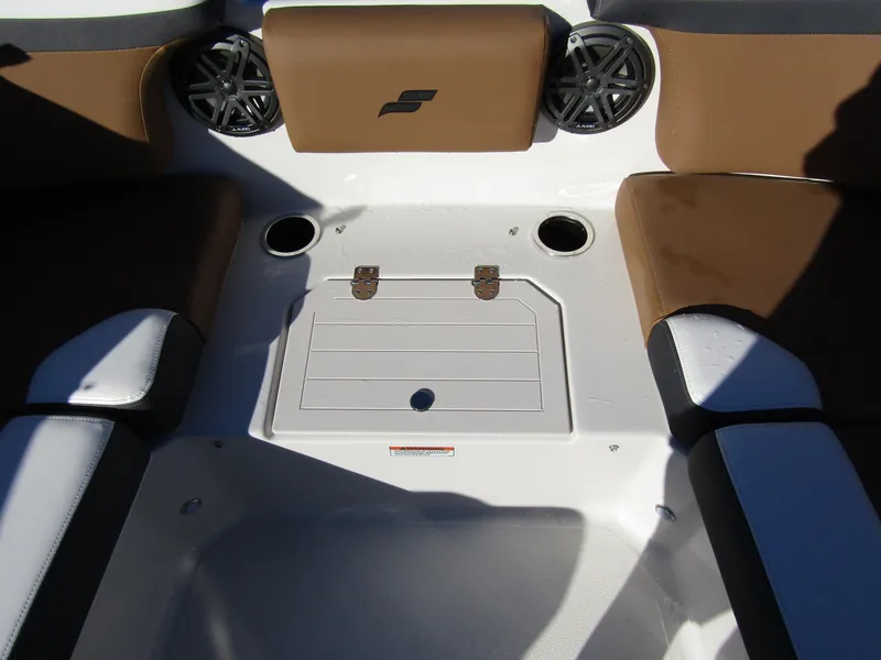Slide: The Image of 2024 Starcraft SVX 231 OB CC boat seating area with storage compartment and cup holders. - 11