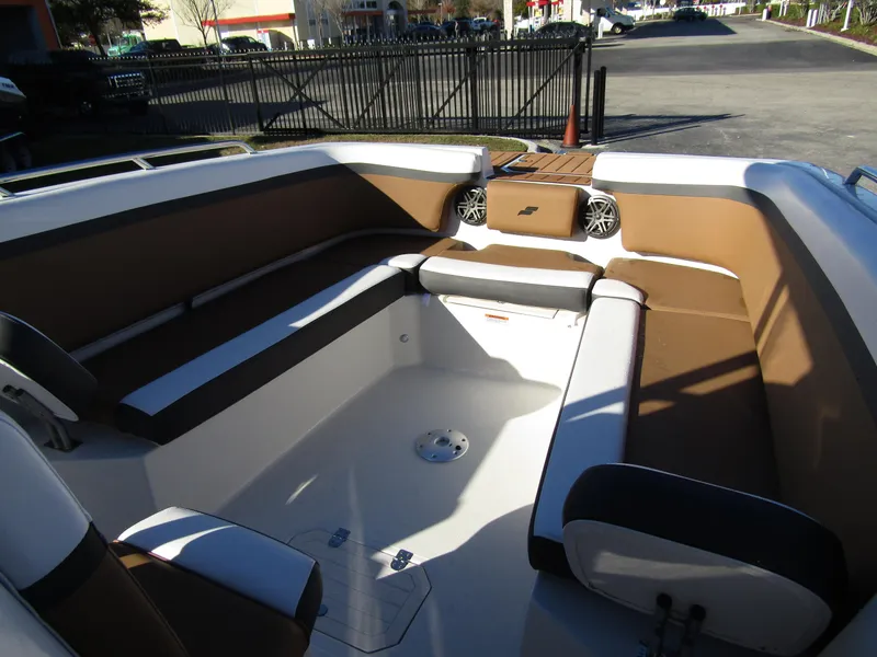 Slide: The Image of 2024 Starcraft SVX 231 OB CC boat interior with brown and white seating. - 9
