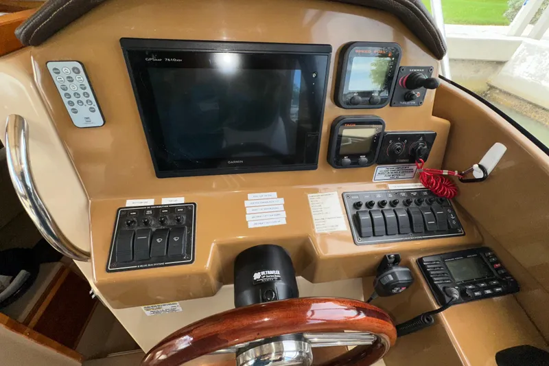 Slide: The Image of 2016 Cutwater C-24 Coupe dashboard with Garmin GPS, controls, and steering wheel. - 10