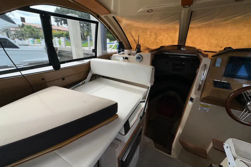 Slide: The Image of Interior of a 2016 Cutwater C-24 Coupe boat, featuring seating and helm area. - 12