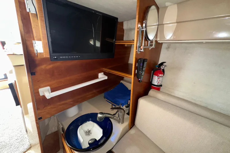 Slide: The Image of Interior of 2016 Cutwater C-24 Coupe with TV, sink, and fire extinguisher. - 14