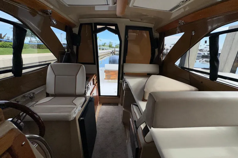 Slide: The Image of Interior of 2016 Cutwater C-24 Coupe boat, featuring seating and windows. - 16
