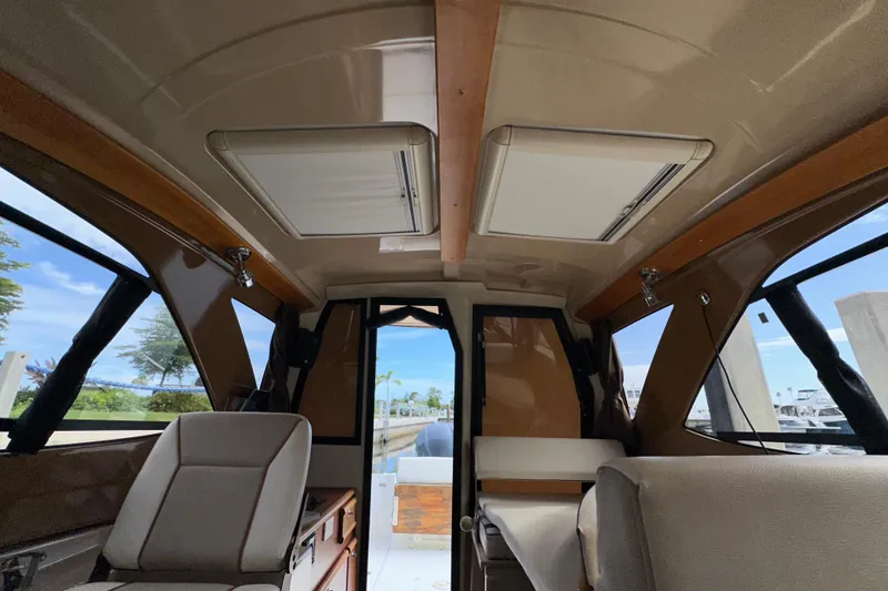 Slide: The Image of Interior of 2016 Cutwater C-24 Coupe boat with seating and windows. - 17