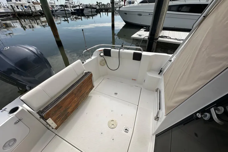 Slide: The Image of 2016 Cutwater C-24 Coupe boat interior with seating and dock view. - 3