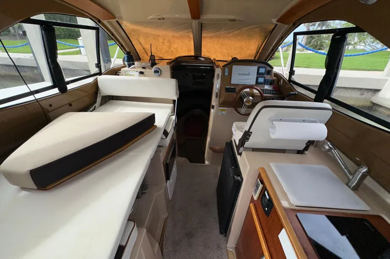 Slide: The Image of Interior of a 2016 Cutwater C-24 Coupe boat with helm and seating area. - 4