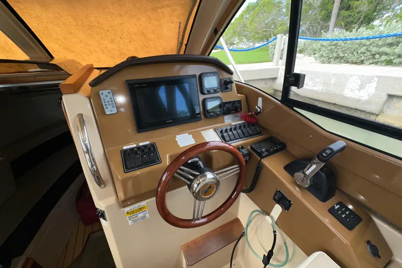 Slide: The Image of 2016 Cutwater C-24 Coupe helm with steering wheel, controls, and navigation display. - 9