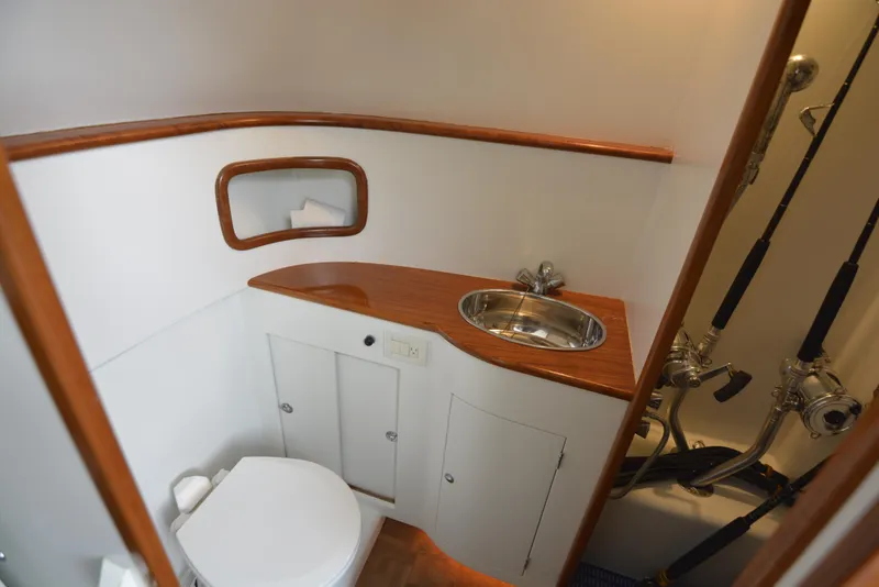 Slide: The Image of Fishing rods stored vertically in a 2007 Gamefisherman 42 Walkaround boat interior. - 10