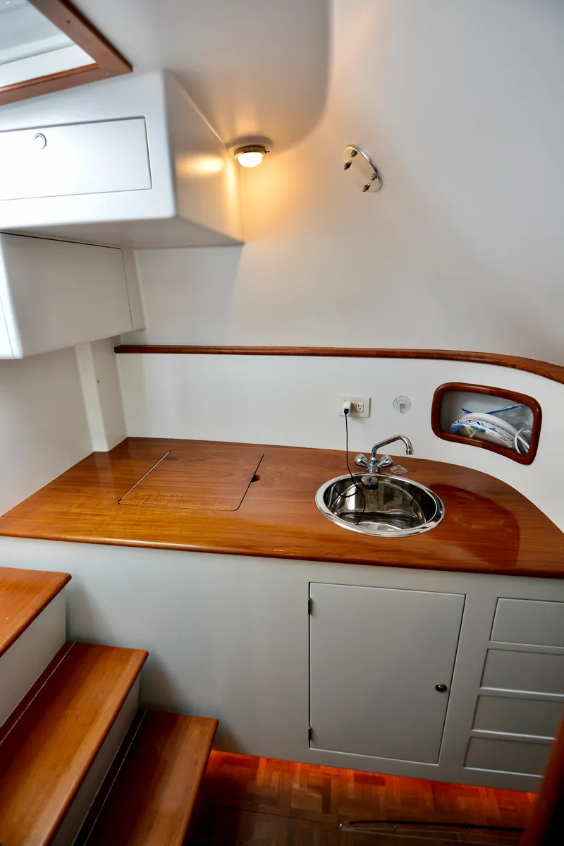 Slide: The Image of Interior of 2007 Gamefisherman 42 Walkaround with wood flooring and built-in storage. - 11