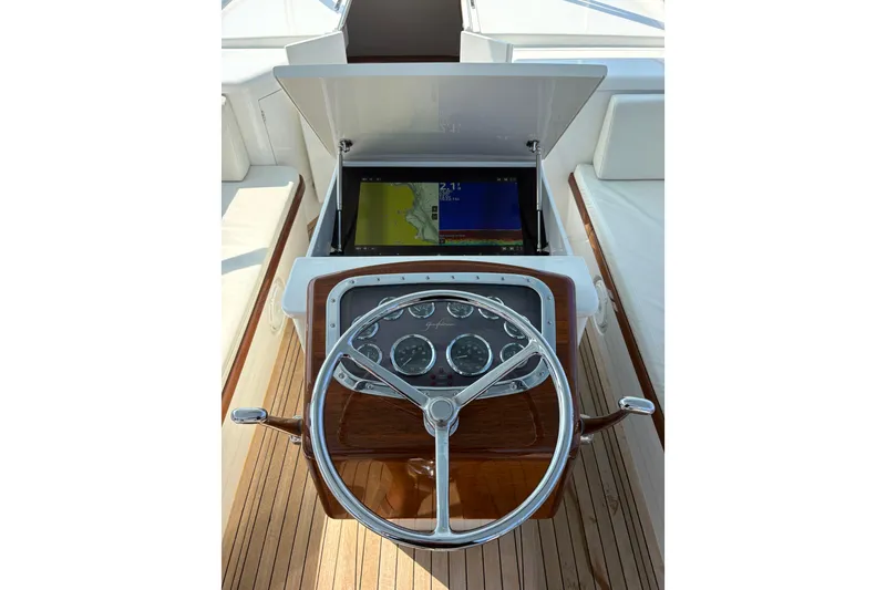 Slide: The Image of 2007 Gamefisherman 42 Walkaround helm with navigation display and classic steering wheel. - 14