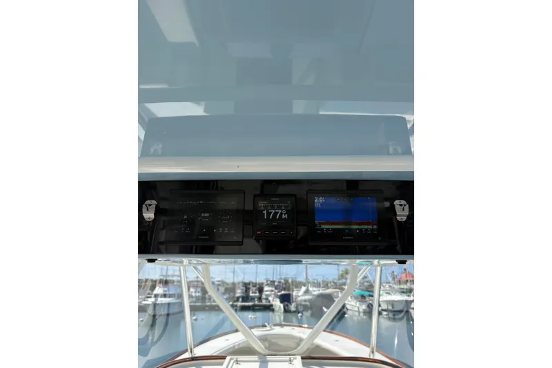Slide: The Image of Open storage compartment on 2007 Gamefisherman 42 Walkaround boat, docked by the water. - 23