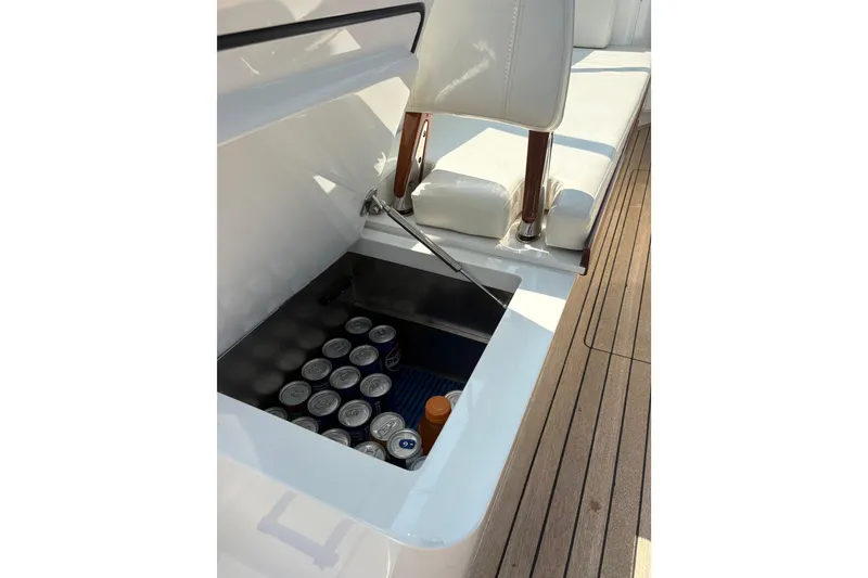 Slide: The Image of Open storage compartment on 2007 Gamefisherman 42 Walkaround boat with wooden deck. - 28