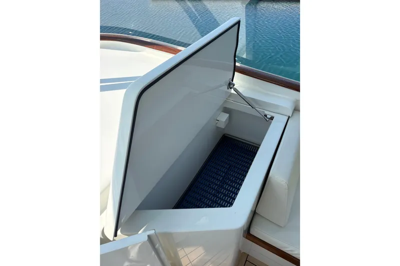 Slide: The Image of Engine compartment of 2007 Gamefisherman 42 Walkaround with open hatch on teak deck. - 29