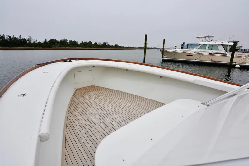 Slide: The Image of 2007 Gamefisherman 42 Walkaround boat deck with fishing chair and rod holders. - 4