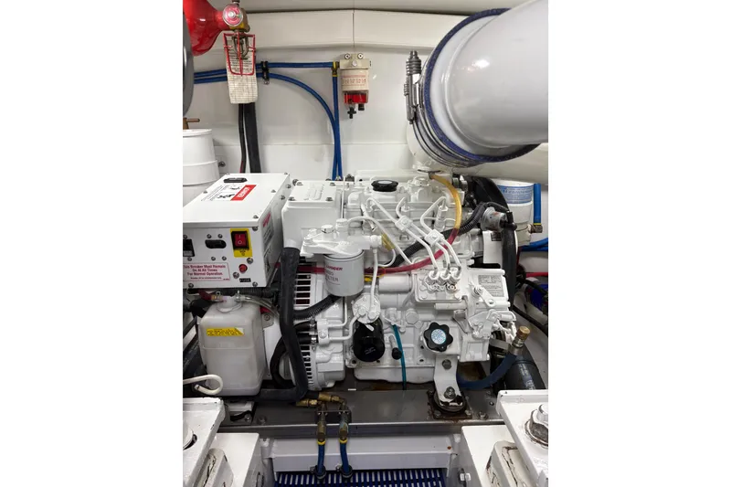 Slide: The Image of 2007 Gamefisherman 42 Walkaround boat engine compartment with open hatch, docked in marina. - 40