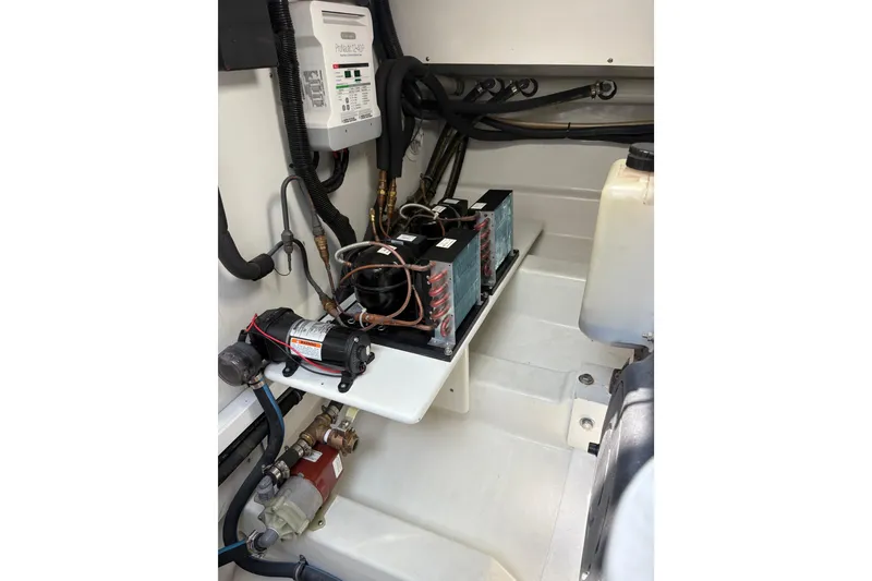 Slide: The Image of Engine compartment of 2007 Gamefisherman 42 Walkaround, showcasing dual engines and mechanical components. - 43