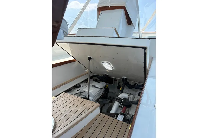 Slide: The Image of Engine compartment of 2007 Gamefisherman 42 Walkaround boat, showcasing mechanical components. - 47