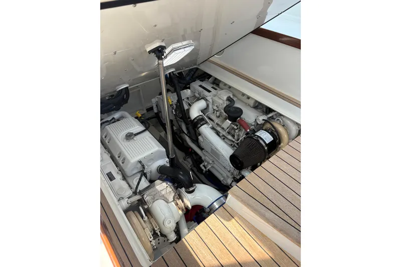 Slide: The Image of Engine compartment of 2007 Gamefisherman 42 Walkaround, showcasing mechanical components and hoses. - 49