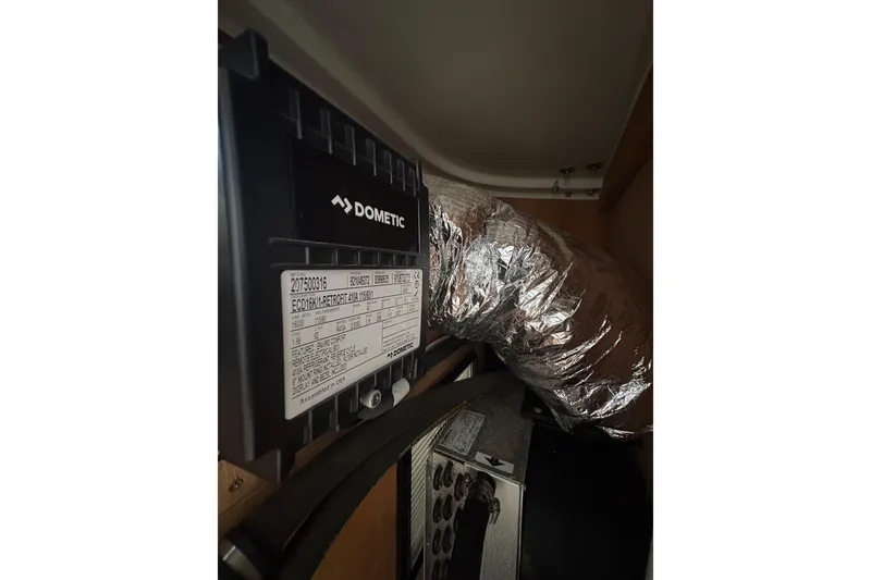 Slide: The Image of 2007 Gamefisherman 42 Walkaround yacht with sleek design, docked in a marina. - 63