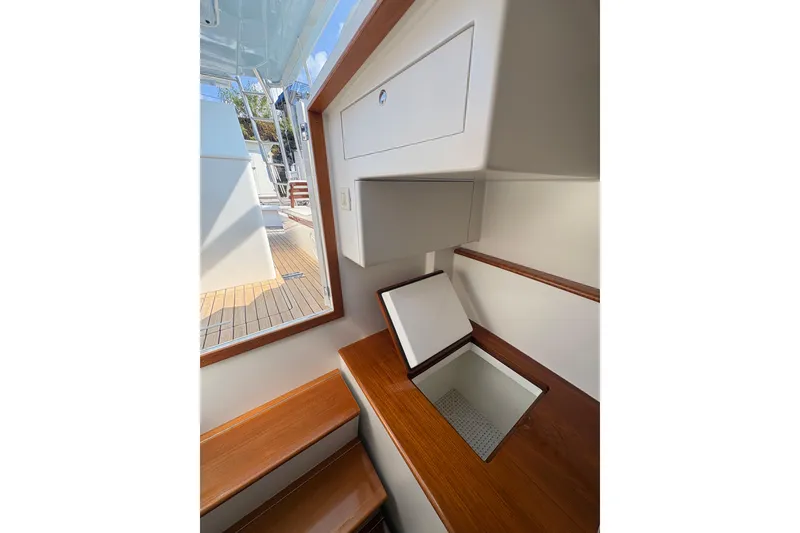 Slide: The Image of 2007 Gamefisherman 42 Walkaround boat docked in marina, featuring spacious deck and sleek design. - 64