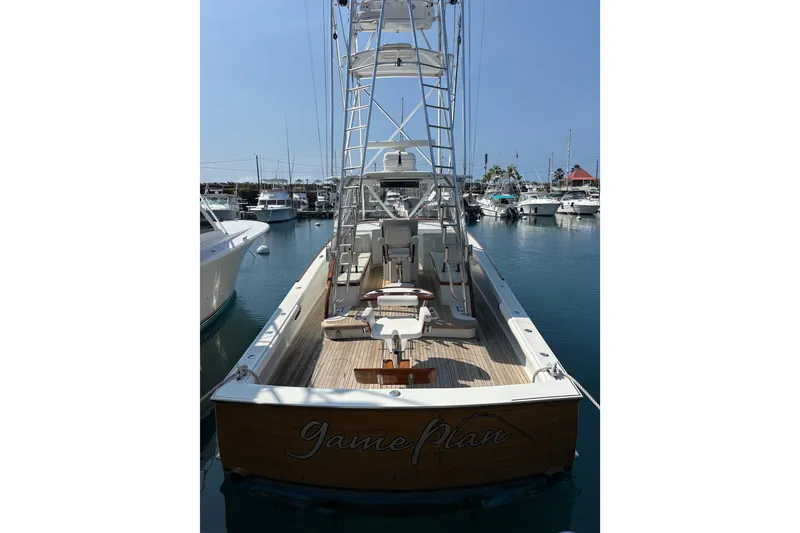 Slide: The Image of 2007 Gamefisherman 42 Walkaround boat docked, featuring a sleek design and tower. - 66