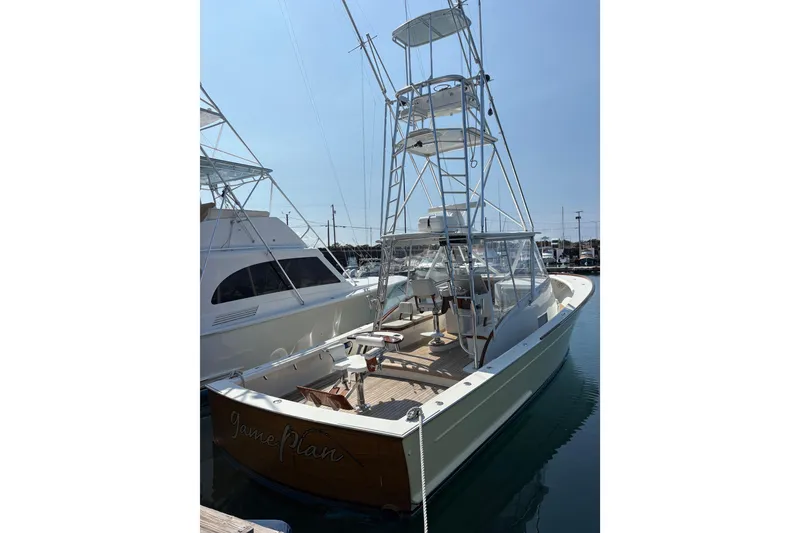 Slide: The Image of 2007 Gamefisherman 42 Walkaround boat detail with logo and marina background. - 67