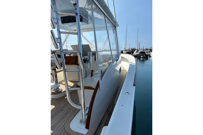 Slide: The Image of 2007 Gamefisherman 42 Walkaround boat interior with helm and ladder, docked at marina. - 69