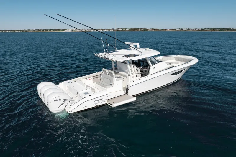 Slide: The Image of 2023 Pursuit S 428 Sport boat on open water, featuring multiple outboard engines. - 1