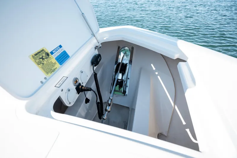 Slide: The Image of 2023 Pursuit S 428 Sport boat anchor compartment with open hatch. - 18