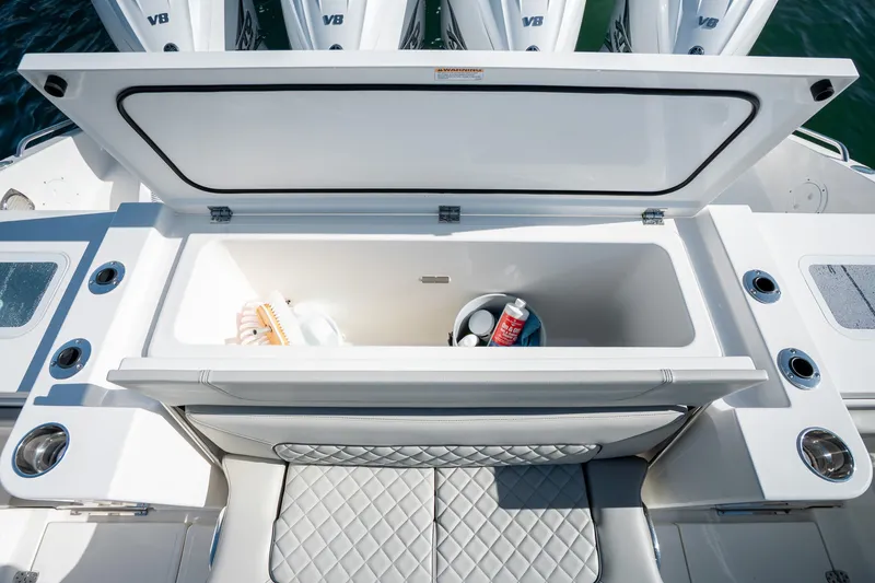 Slide: The Image of 2023 Pursuit S 428 Sport boat storage compartment with open lid, showcasing interior space. - 20
