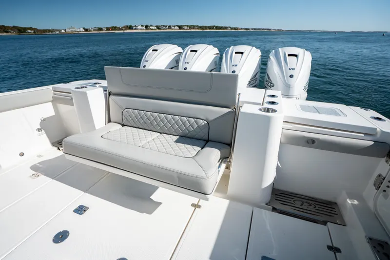 Slide: The Image of 2023 Pursuit S 428 Sport boat with luxurious seating and powerful engines on open water. - 23