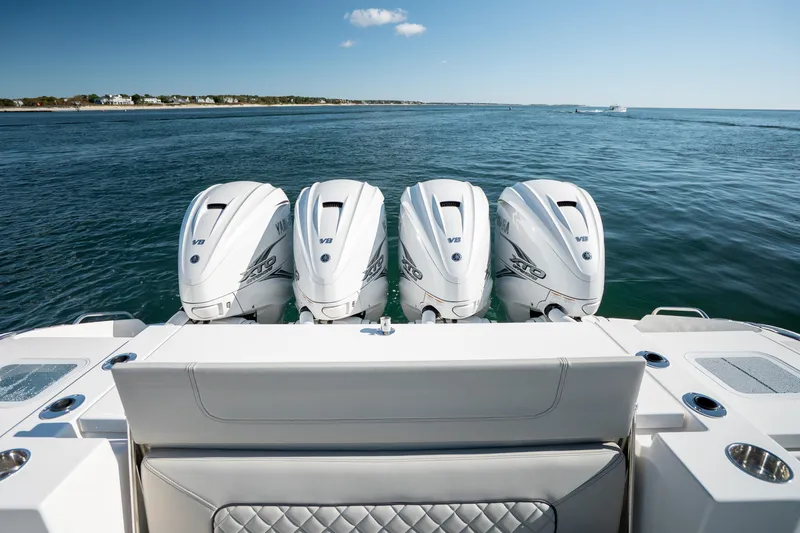 Slide: The Image of 2023 Pursuit S 428 Sport boat with four powerful outboard engines on open water. - 24