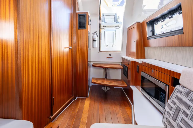 Slide: The Image of Luxurious interior of 2023 Pursuit S 428 Sport boat with wood finishes and modern amenities. - 28