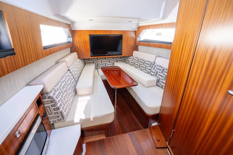 Slide: The Image of Luxurious interior of 2023 Pursuit S 428 Sport boat with elegant seating and wood finishes. - 30
