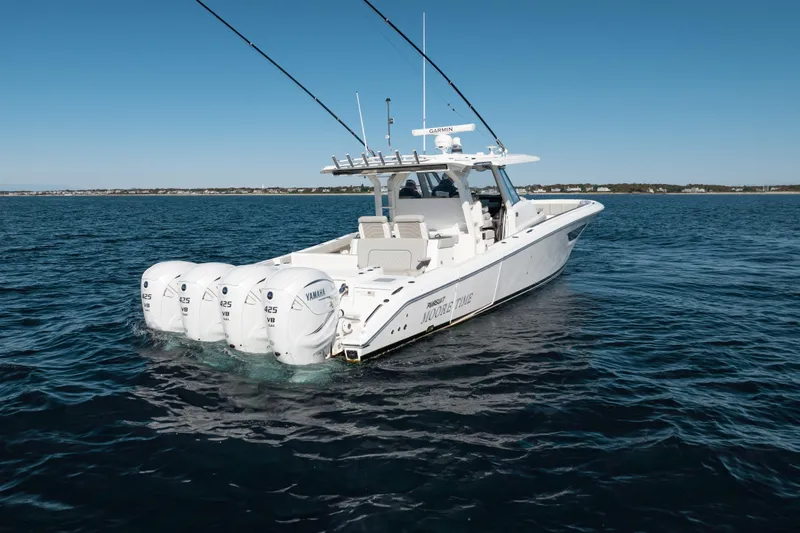 Slide: The Image of 2023 Pursuit S 428 Sport boat with four Yamaha engines on open water. - 4