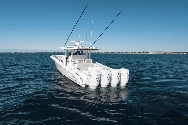 Slide: The Image of 2023 Pursuit S 428 Sport boat with four engines on open water. - 7