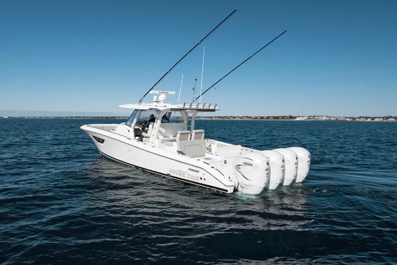 Slide: The Image of 2023 Pursuit S 428 Sport boat on open water with four Yamaha engines. - 8