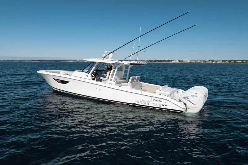 Slide: The Image of 2023 Pursuit S 428 Sport boat on open water, clear sky, side view. - 9