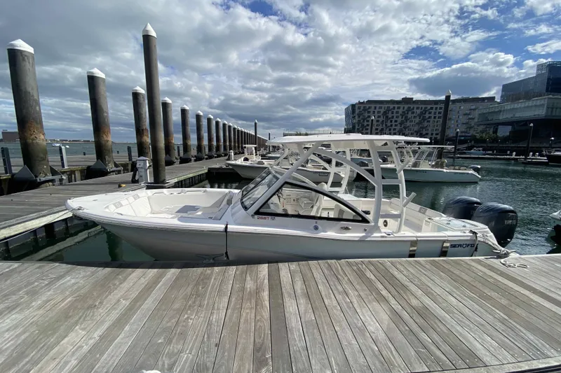 Slide: The Image of 2025 Sea Fox 268 Traveler boat docked at marina under cloudy sky. - 4