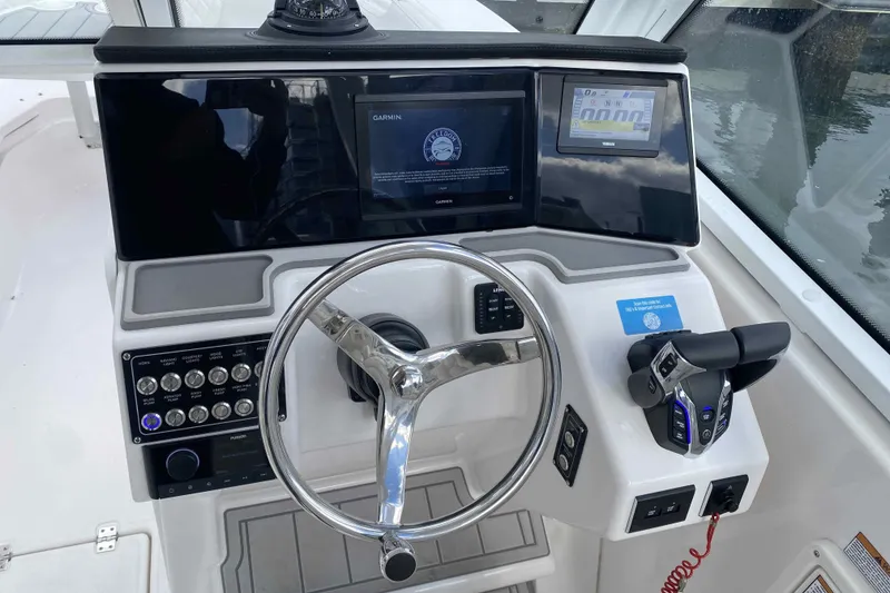 Slide: The Image of Steering console of 2025 Sea Fox 268 Traveler with modern navigation displays and controls. - 5